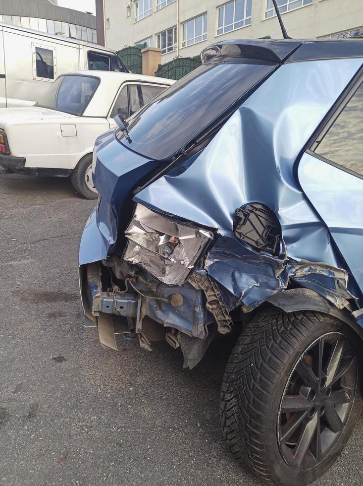 Rückansicht eines abgestürzten blauen Hatchback-Autos auf der Straße foto