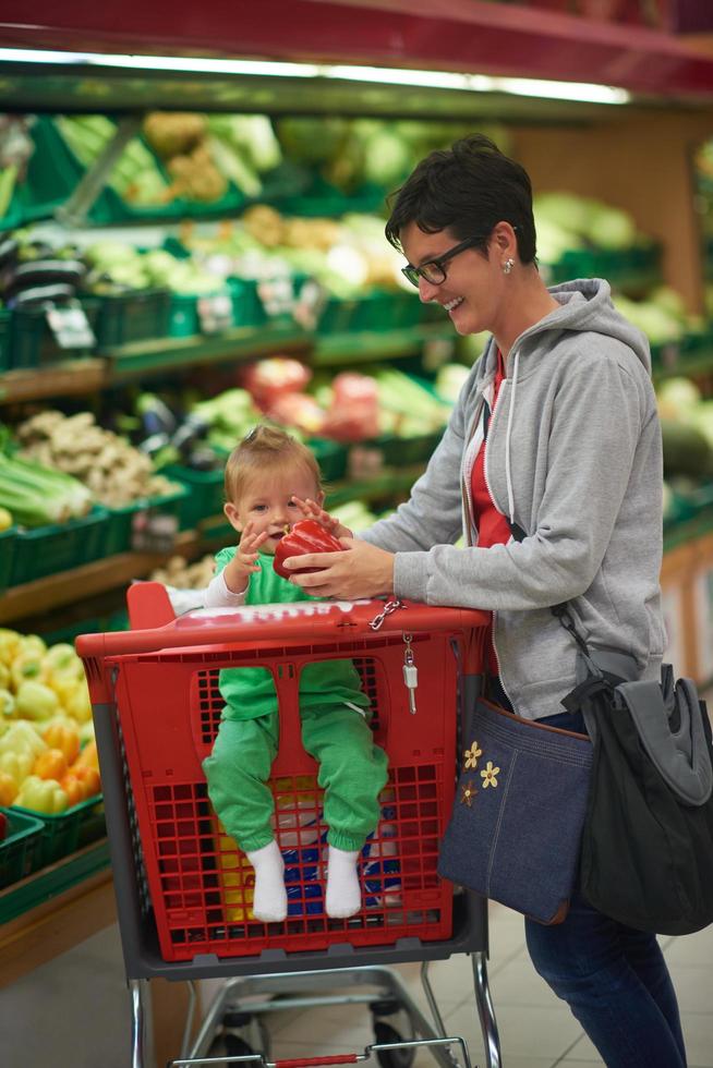 Mutter mit Baby beim Einkaufen foto