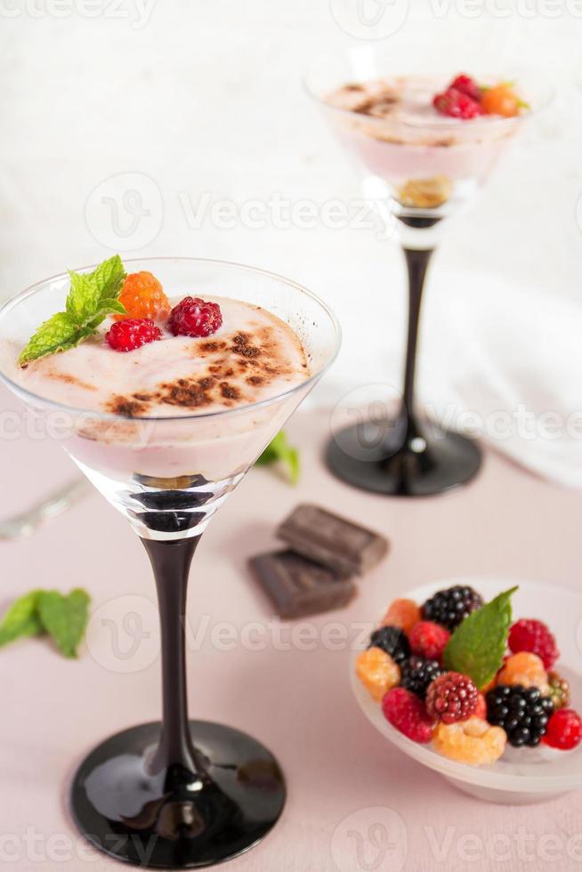 Milchdessert mit Beeren in hohen Gläsern. selektiver Fokus. foto