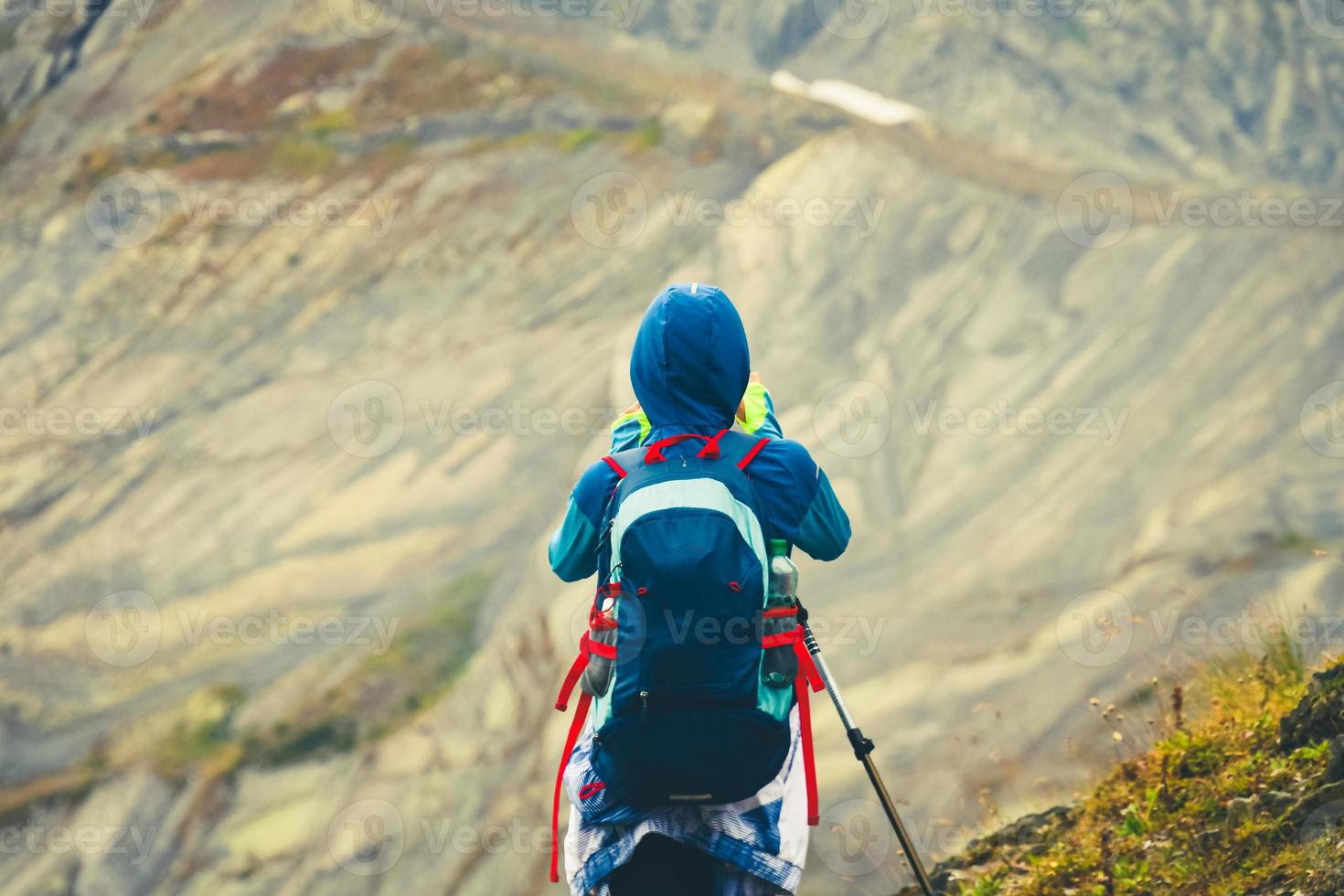 rückansicht frau wanderer mit rucksack auf bergaussichtspunkt fotografieren der landschaft in racha, georgian region foto