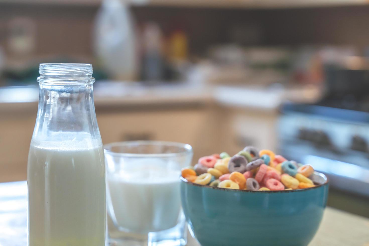 schüssel mit buntem kindermüsli und milch isoliert auf holztisch mit textraum foto