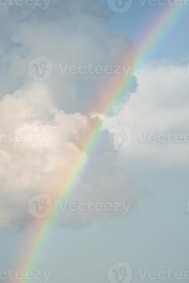 schöne aussicht auf den regenbogen inmitten flauschiger wolken im himmel an einem sonnigen tag foto