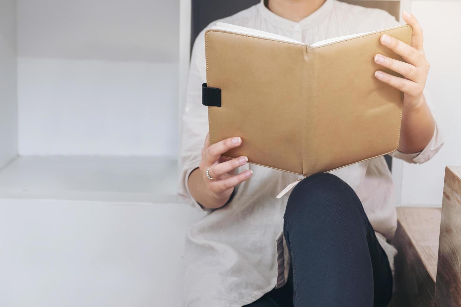 junge Hipsterfrau, die ein Buch liest foto