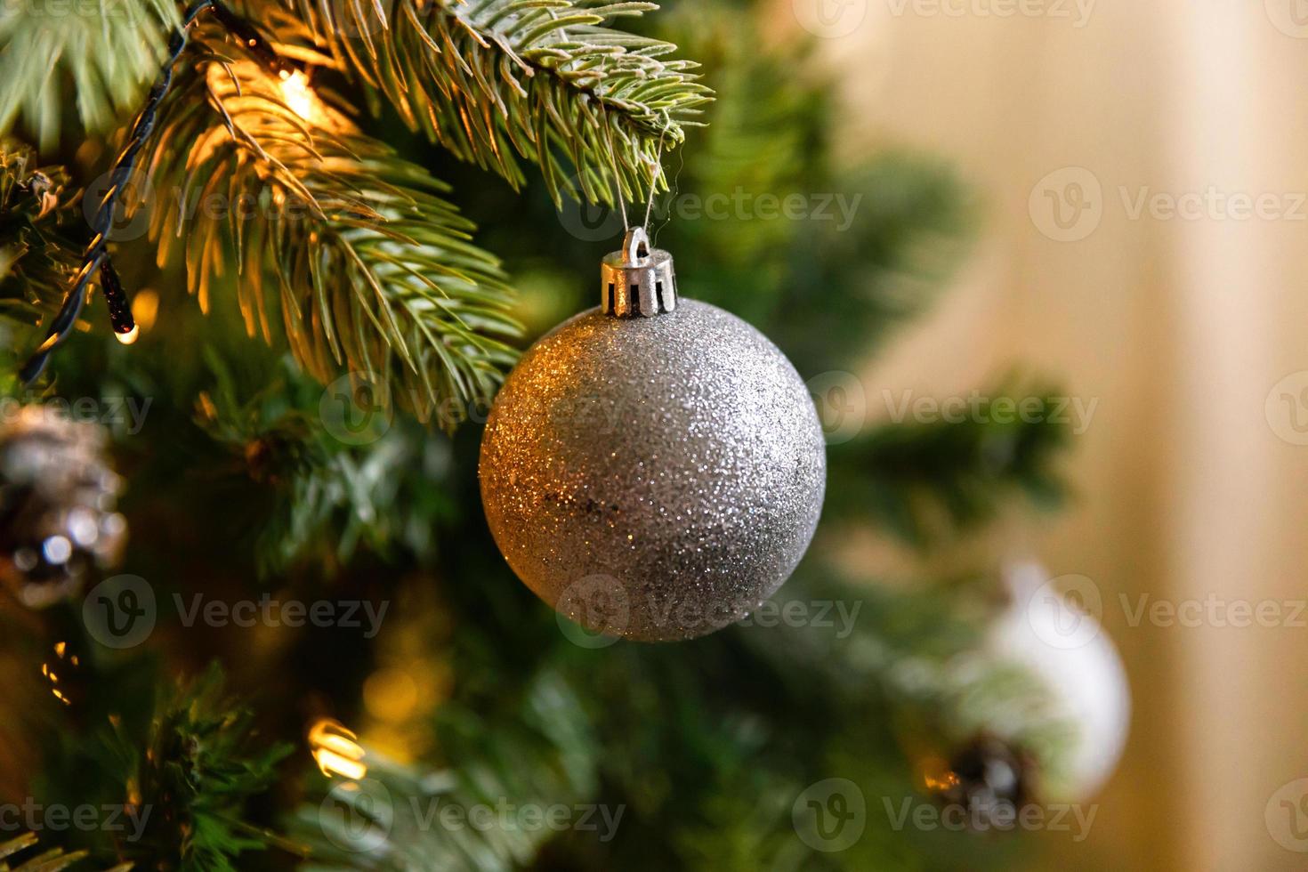 klassischer weihnachtlich geschmückter neujahrsbaum. weihnachtsbaum mit weißen und silbernen dekorationen, schmuckspielzeug und ball. moderne Innenarchitekturwohnung im klassischen Stil. Heiligabend zu Hause. foto