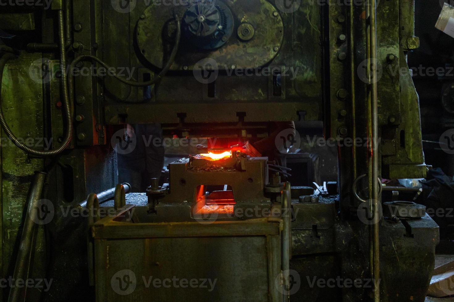 frisch geschmiedete Werkstücke aus heißem Stahl nach dem Pressformen in einer schmutzigen dunklen Fabrik foto