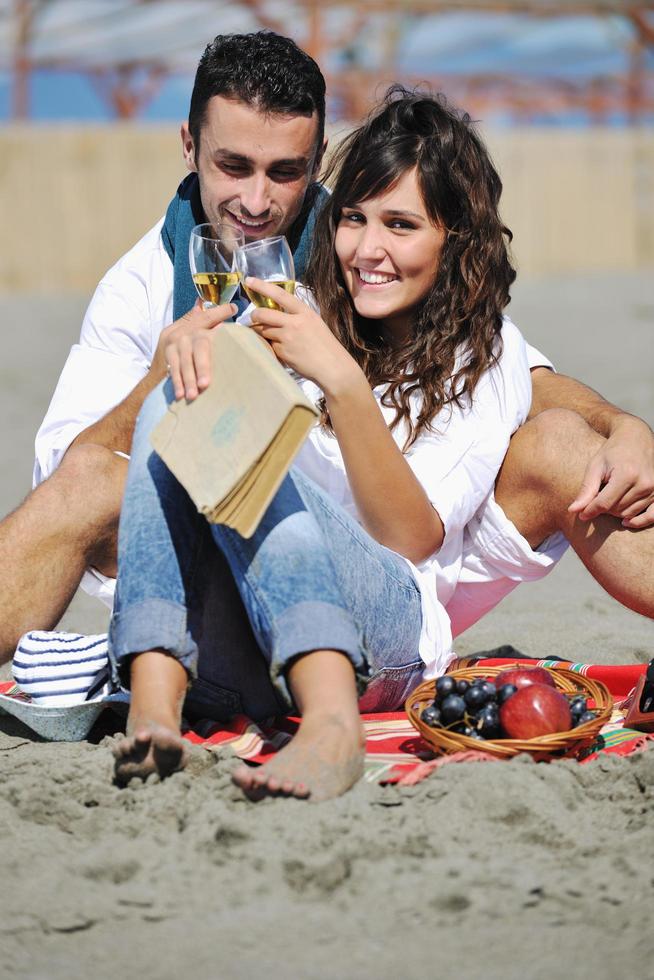 junges Paar beim Picknick am Strand foto