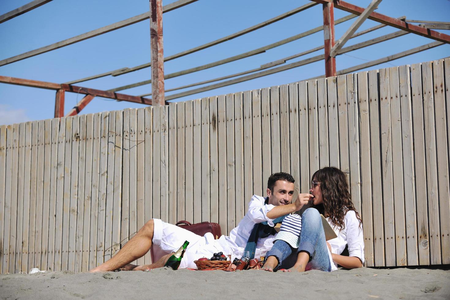 junges Paar beim Picknick am Strand foto