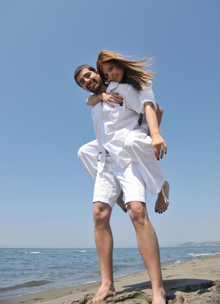 glückliches junges Paar viel Spaß am Strand foto