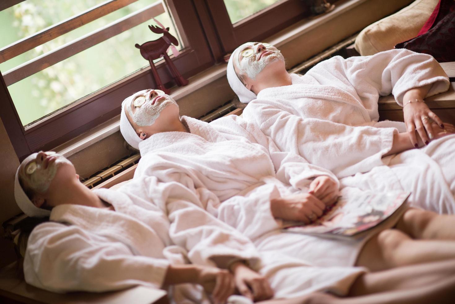 frauen bekommen im spa eine gesichtsmaske aus ton foto