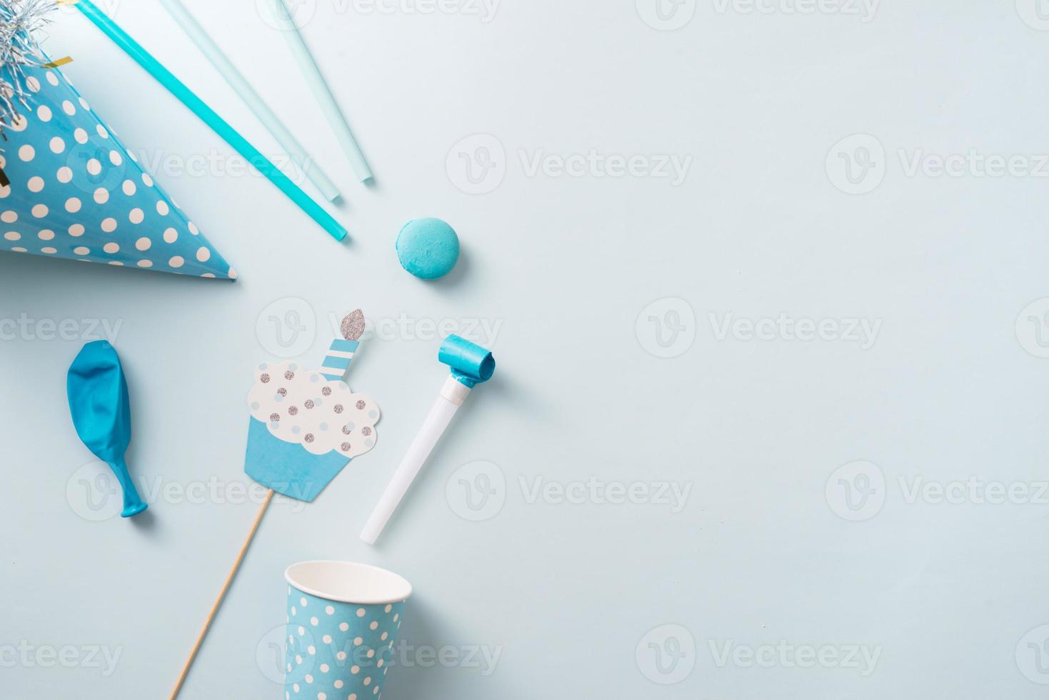 Junge Geburtstagsdekorationen. Blaue Tischdekoration von oben mit Muffins, Getränken und Party-Gadgets. Hintergrundlayout mit freiem Textbereich. foto