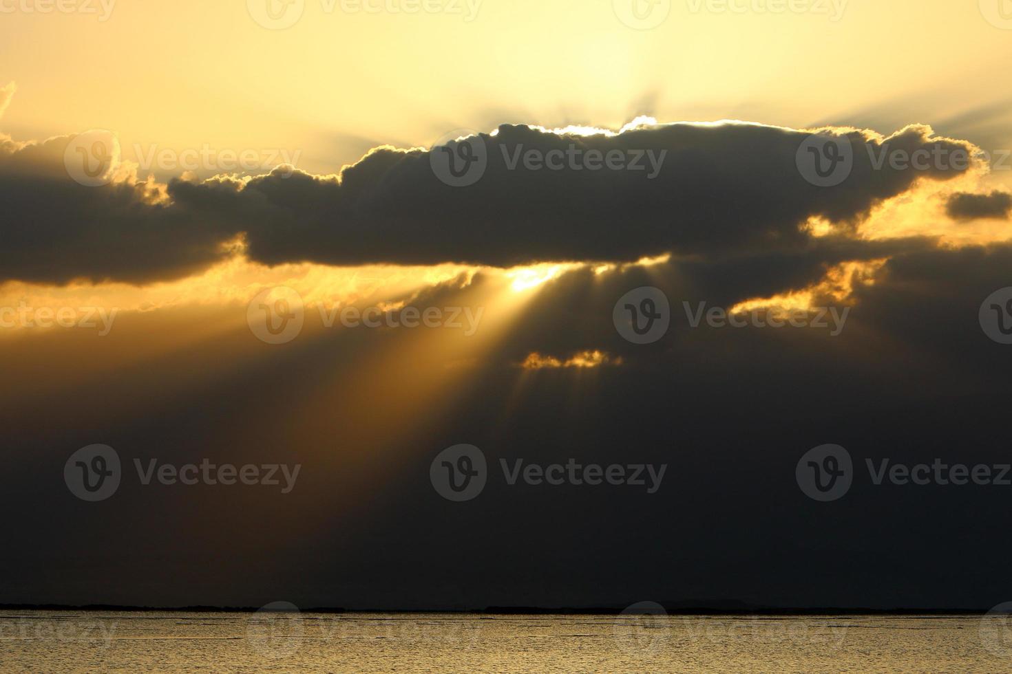 Sonnenaufgang am Ufer des Toten Meeres in Israel. die sonne geht hinter den bergen in jordanien auf. foto