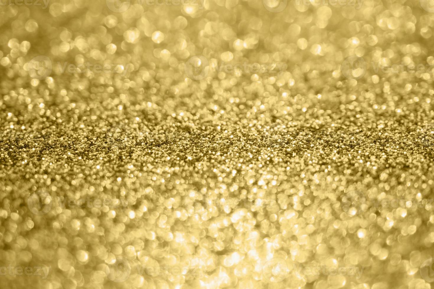 abstrakter Unschärfe-Goldglitter-Schein defokussierter Bokeh-heller Hintergrund foto