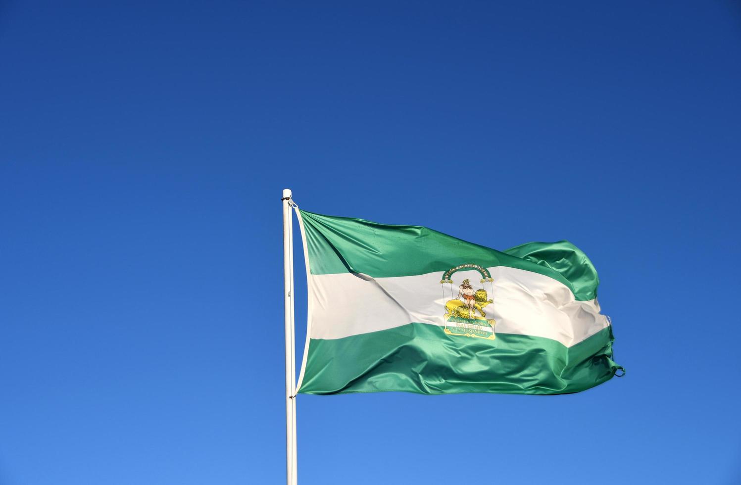 andalusische Flagge mit blauem Himmel foto