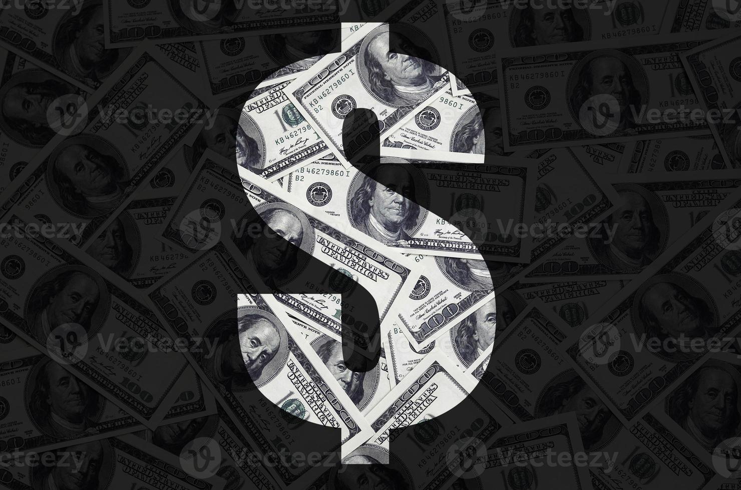 das symbol dollar auf schwarzem hintergrund. ein Muster aus dem Satz verstreuter Dollarscheine als Füllzeichen foto