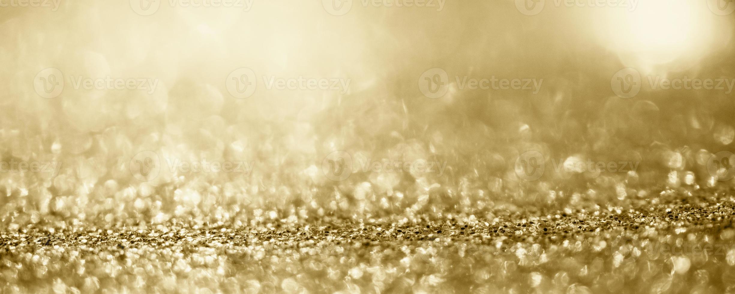 abstraktes goldglitter funkeln verschwommen mit bokeh hintergrund foto