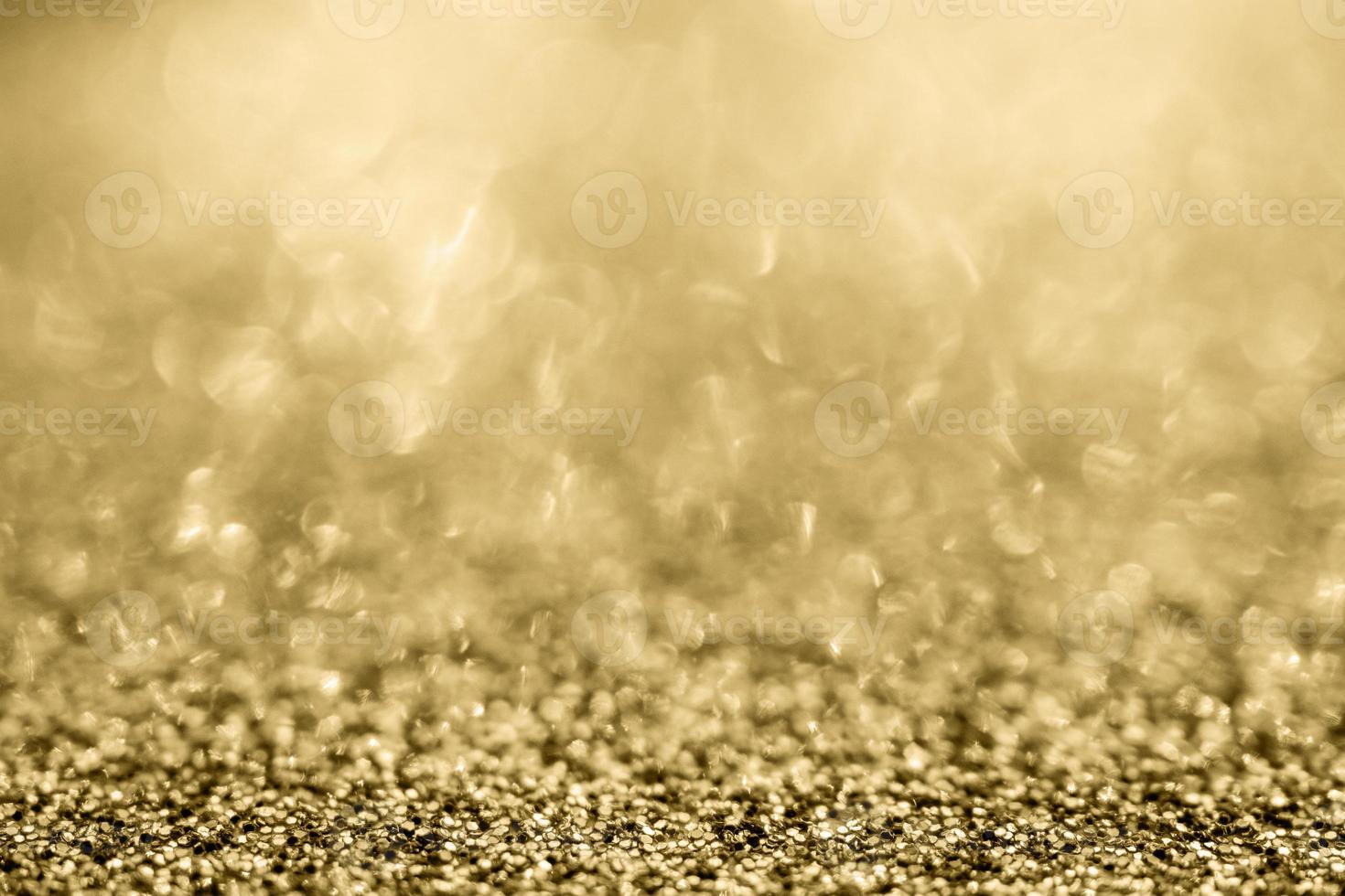 abstraktes goldglitter funkeln verschwommen mit bokeh hintergrund foto
