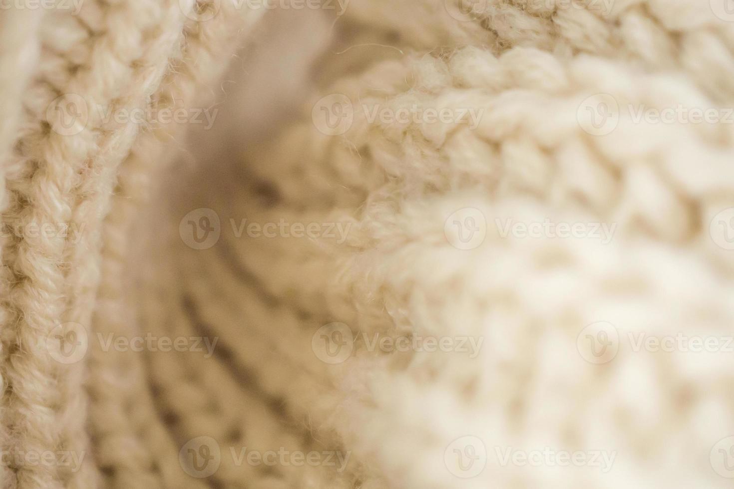 Closeup beige gestrickter Wollstoff Hintergrund foto