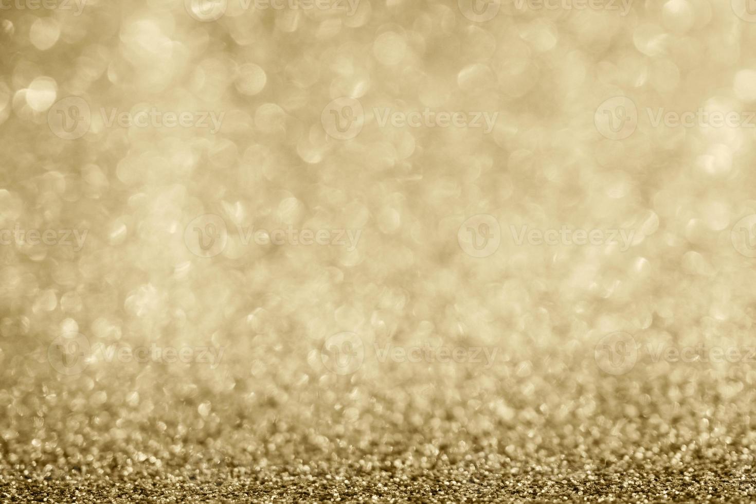 abstraktes goldglitter funkeln verschwommen mit bokeh hintergrund foto