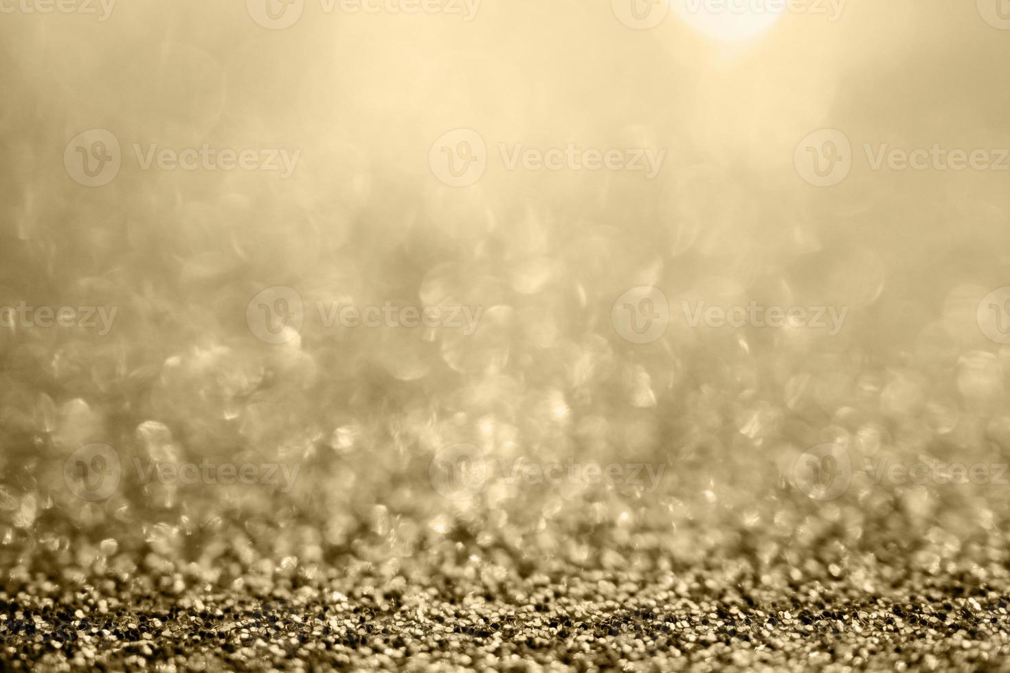 abstraktes goldglitter funkeln verschwommen mit bokeh hintergrund foto