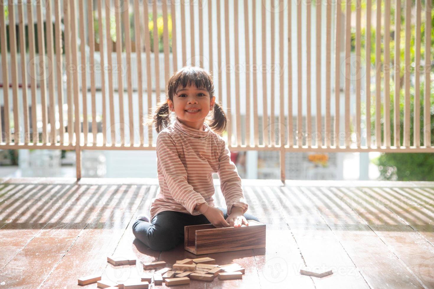 Kinder spielen mit einem Spielzeugdesigner auf dem Boden des Kinderzimmers foto