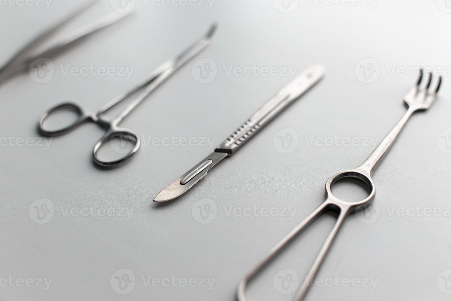 Stahlskalpell mit medizinischen Werkzeugen auf einem weißen Tisch. foto