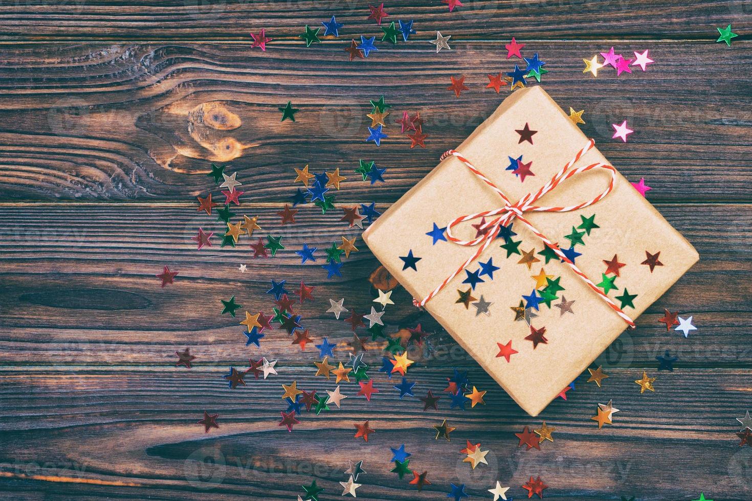 einfaches weihnachtsgeschenk mit roter schnur und dekorsternen. getönt foto