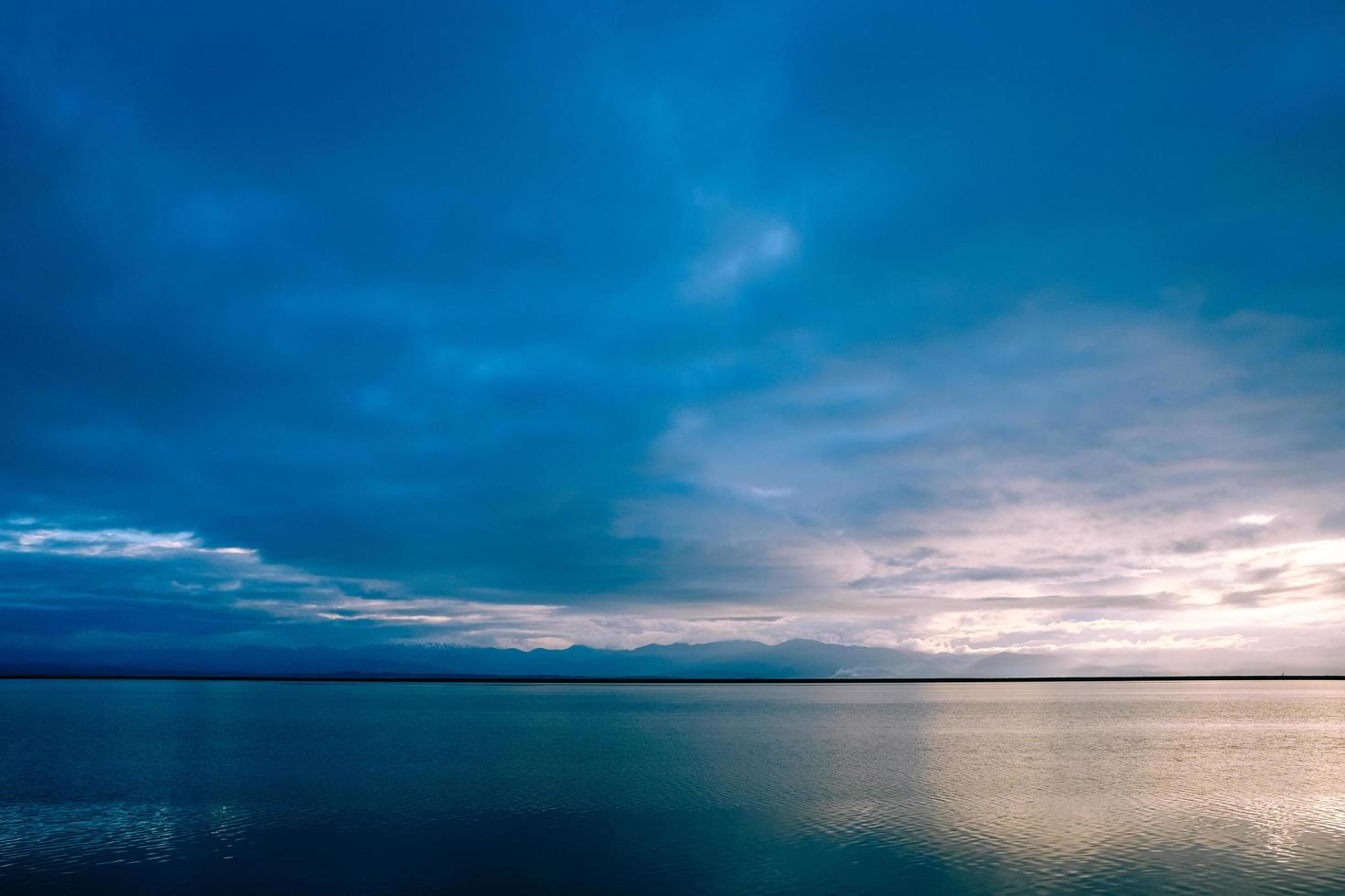 blauer Himmel über ruhiger See foto