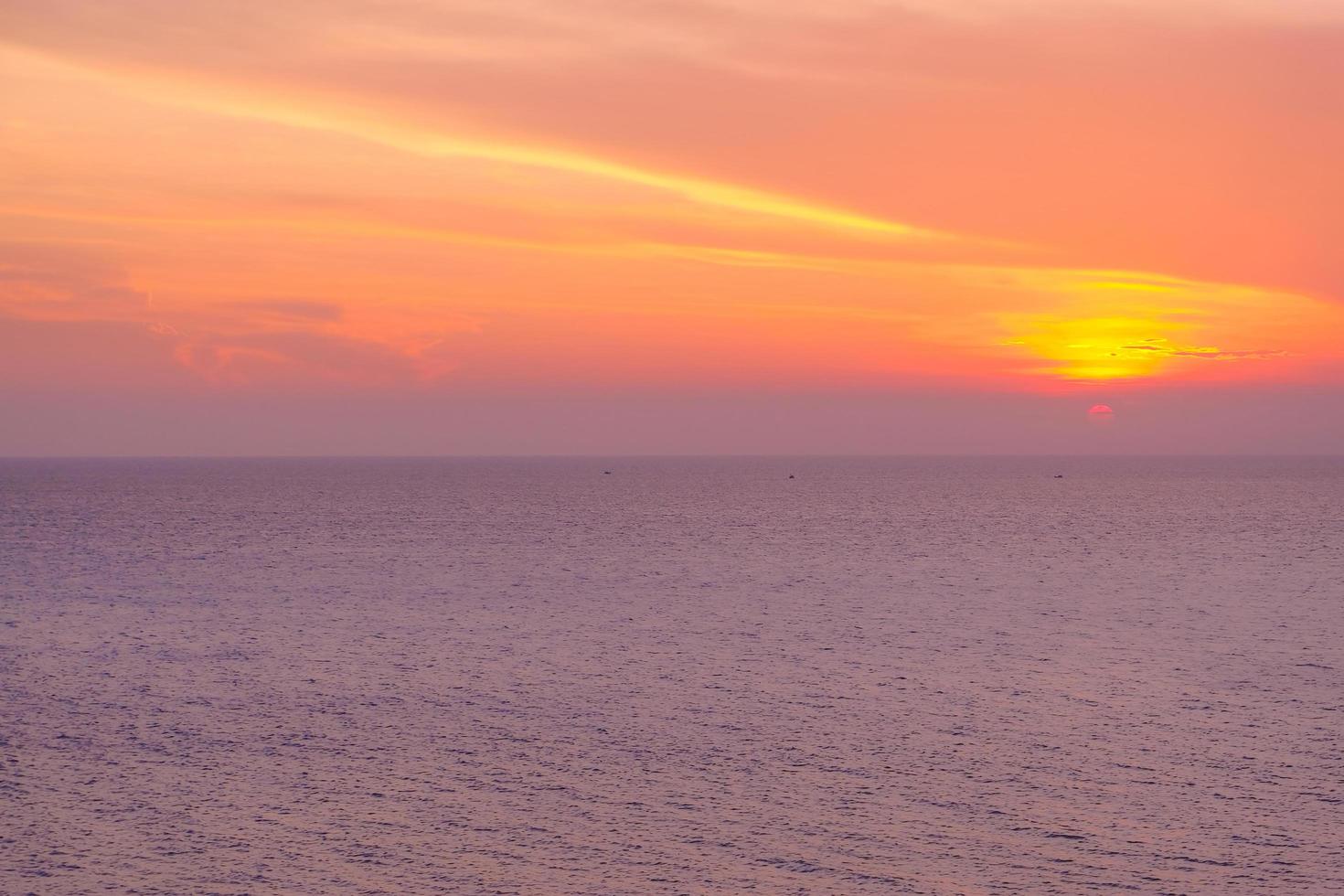 schöner sonnenuntergang über dem meer am tropischen strand mit blauem himmel und wolken für reisen in der urlaubsentspannungszeit foto