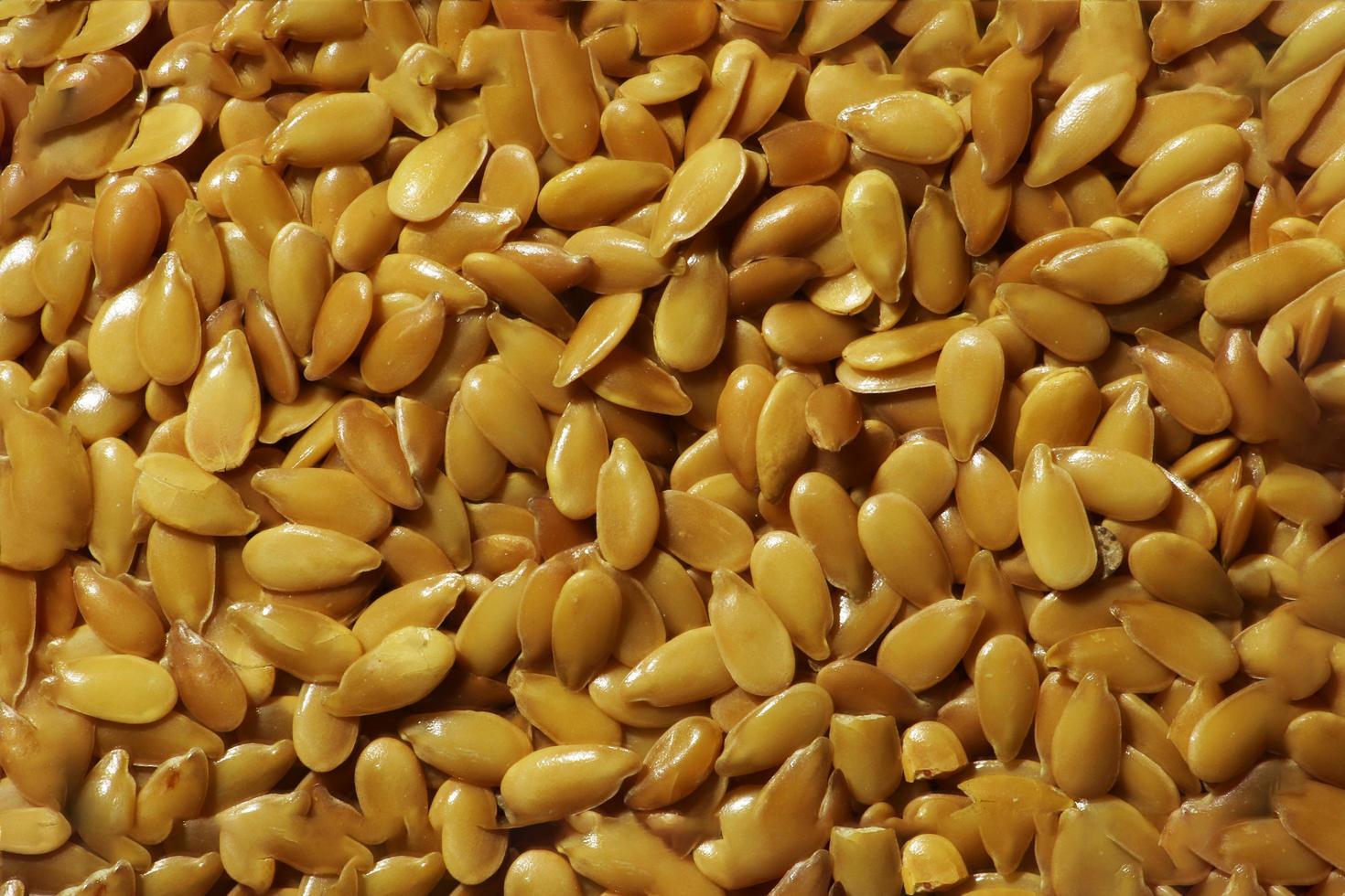 Fotografie des glänzenden goldenen Leinsamenmusters für Nahrungsmittelhintergrund foto