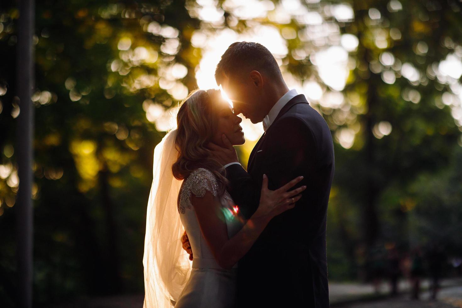 Sommersonne hinter einem schönen Hochzeitspaar foto