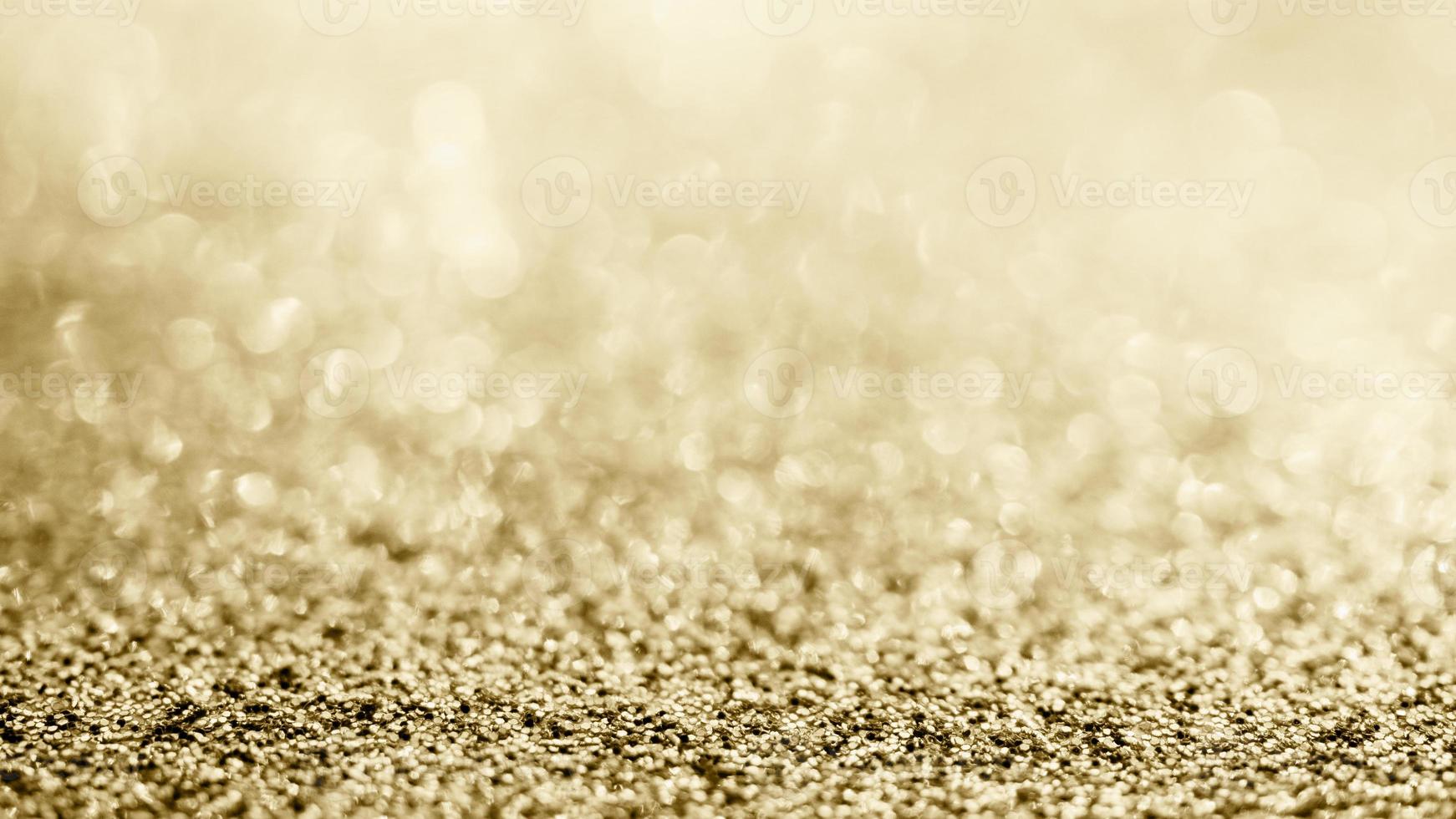 abstraktes goldglitter funkeln verschwommen mit bokeh hintergrund foto