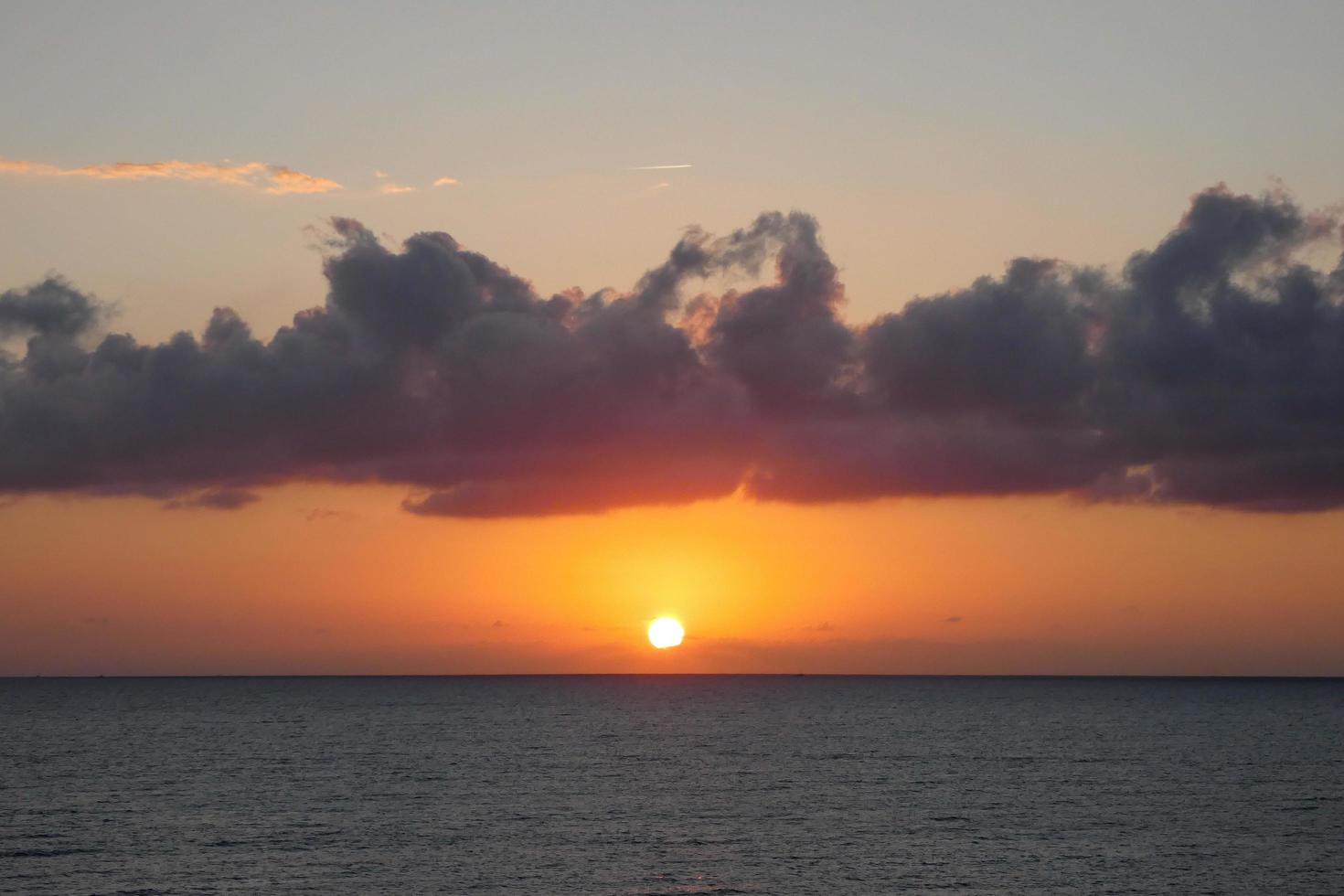 Sonnenscheibe, die über dem Horizont des Meeres aufgeht, Sonnenaufgang, Morgendämmerung foto