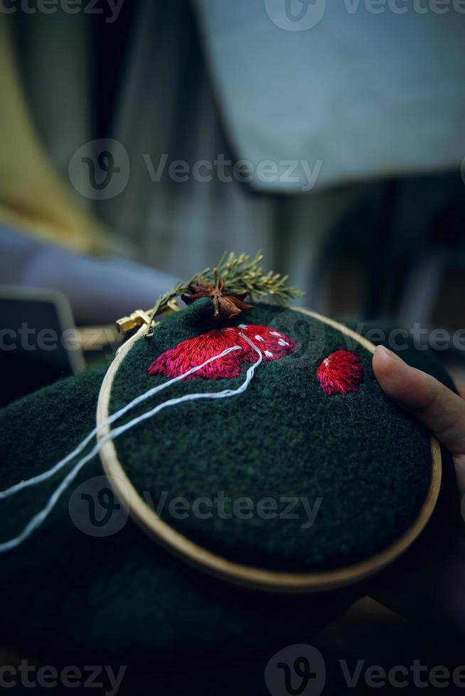 Stickprozess mit Baumwollfaden von Pilzen Hut. foto