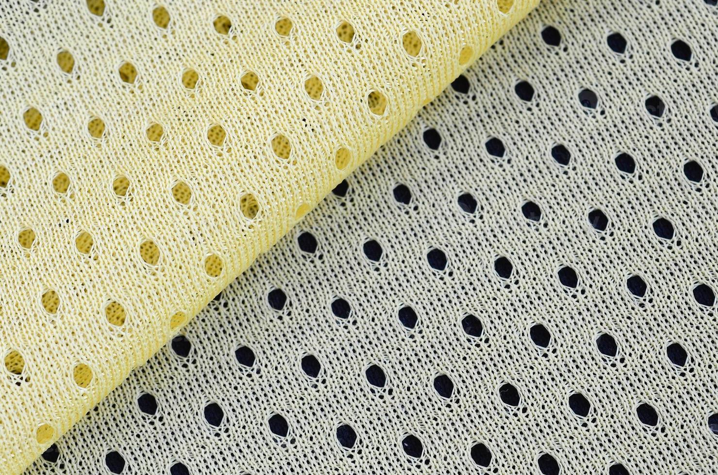 Gelbes Mesh-Sportbekleidungsstoff-Textil-Hintergrundmuster foto