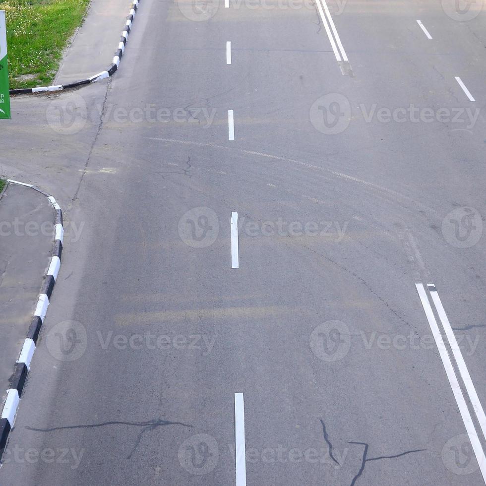 beschädigte schlechte asphaltstraße mit schlaglöchern. Patch-Reparatur von Asphalt foto