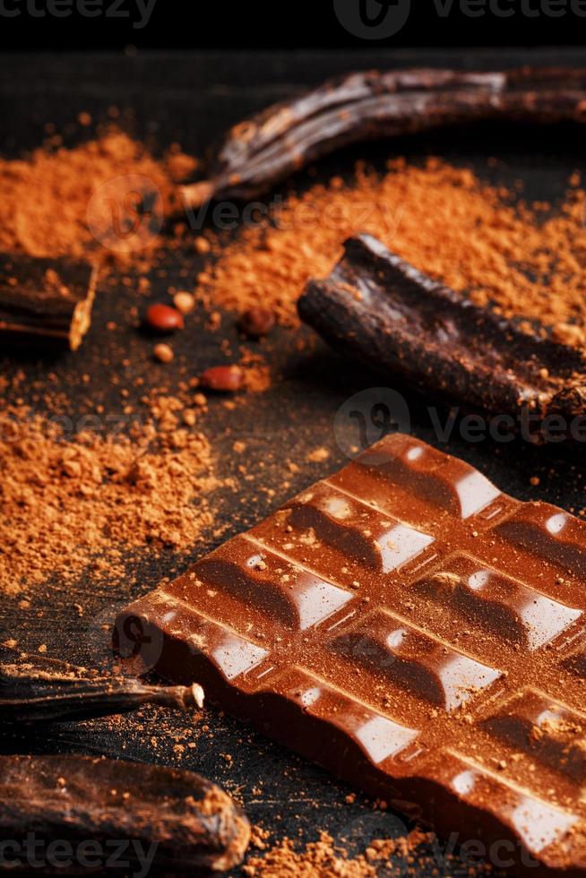 die Schoten der Johannisbrot-Schokoriegel auf schwarzem Hintergrund. foto