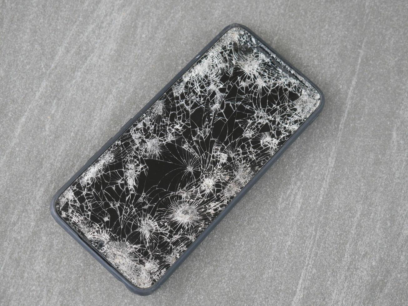 Das Smartphone schlug auf dem Boden auf, es fiel in eine Ritze. foto