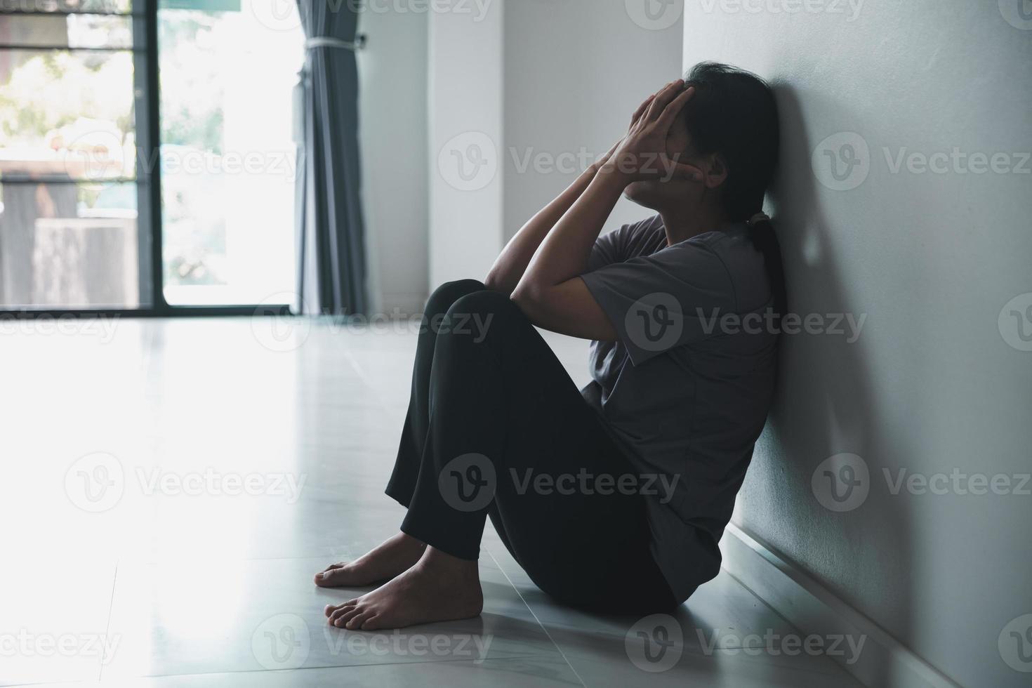 Schizophrenie mit einsamem und traurigem Depressionskonzept der psychischen Gesundheit. depressive frau, die zu hause an der wand sitzt, mit einem schatten an der wand, der sich elend fühlt. Frauen sind depressiv, ängstlich und unglücklich. foto