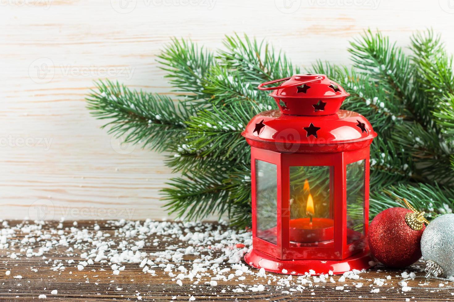 Laterne und Weihnachtsbaum über Schnee auf Holzhintergrund foto