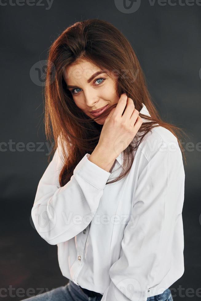 junge schöne Frau posiert für die Kamera im Studio foto