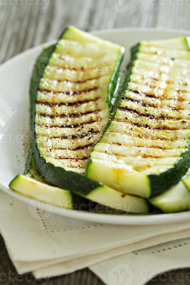 Gegrillte Zucchini auf einem weißen Teller foto