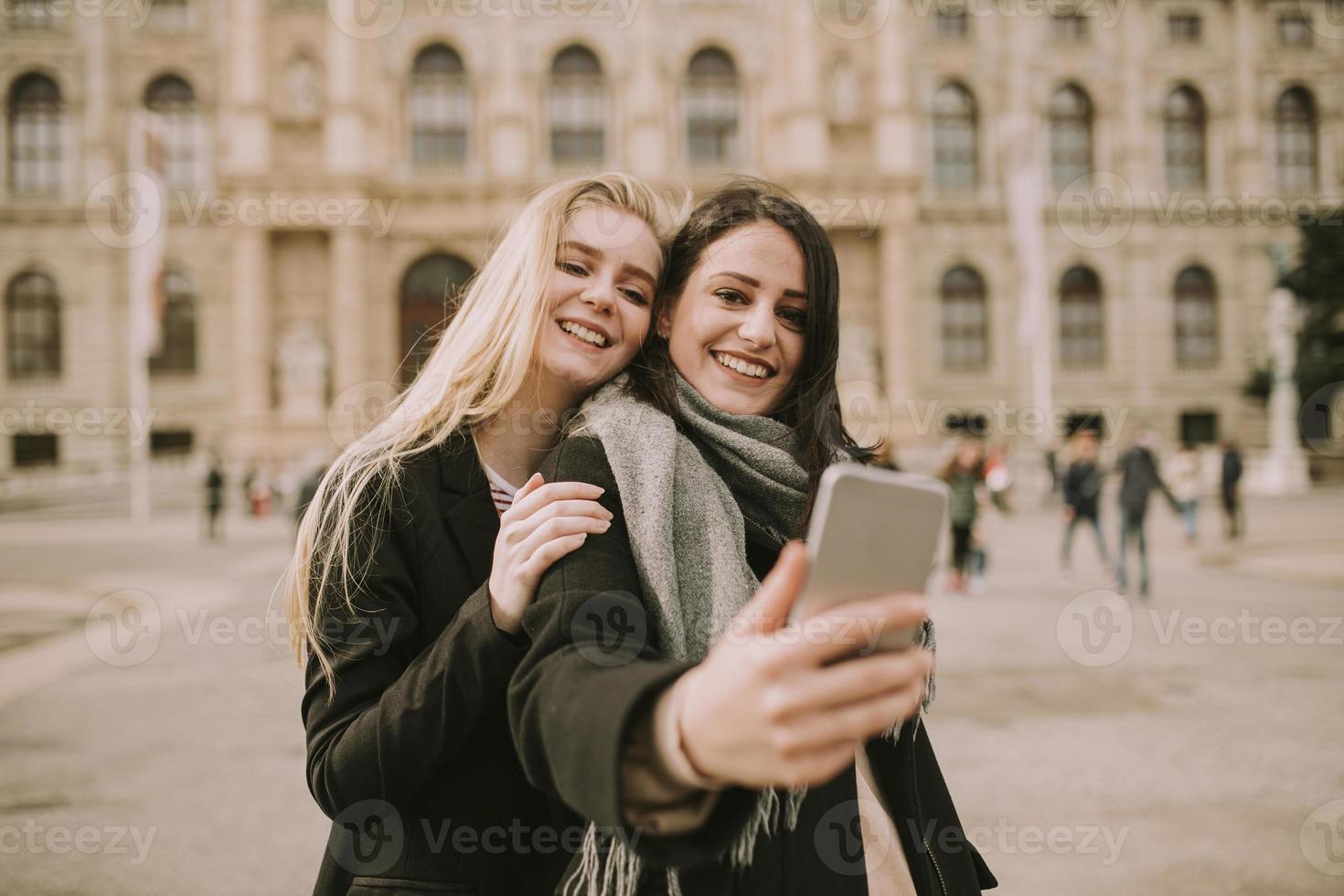 junge weibliche touristen, die selfie mit handyfoto im zentrum von wien, österreich, machen foto