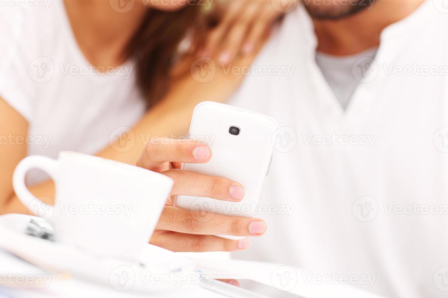 Nahaufnahme von Händen und Smartphone in einem Café foto
