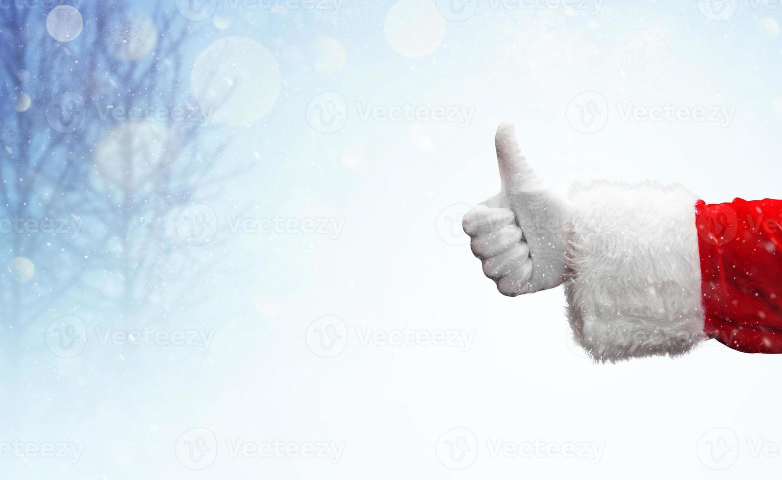 Weihnachtsmann-Hand zeigt Daumen hoch Geste. foto
