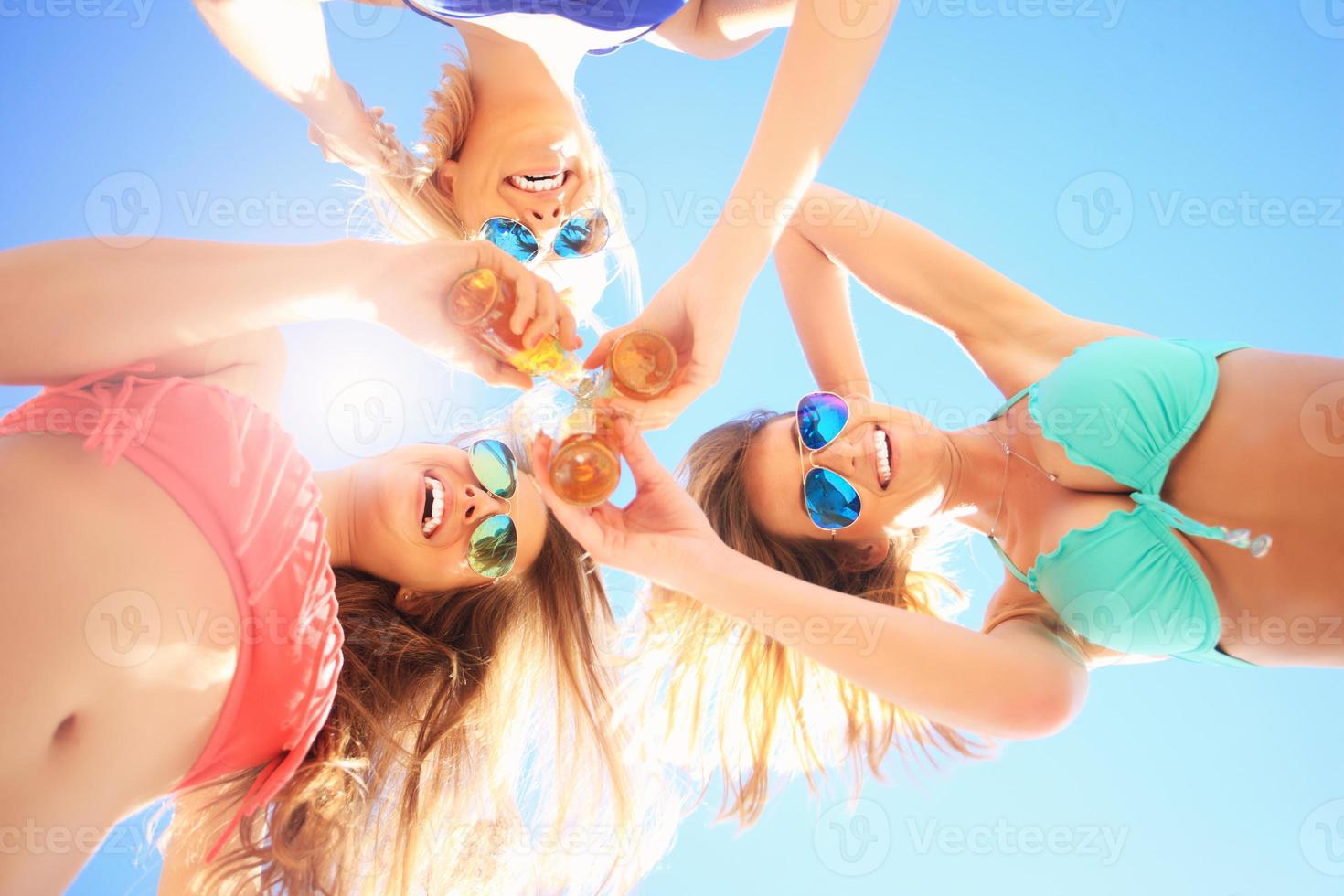 gruppe von freunden, die bier am strand trinken foto