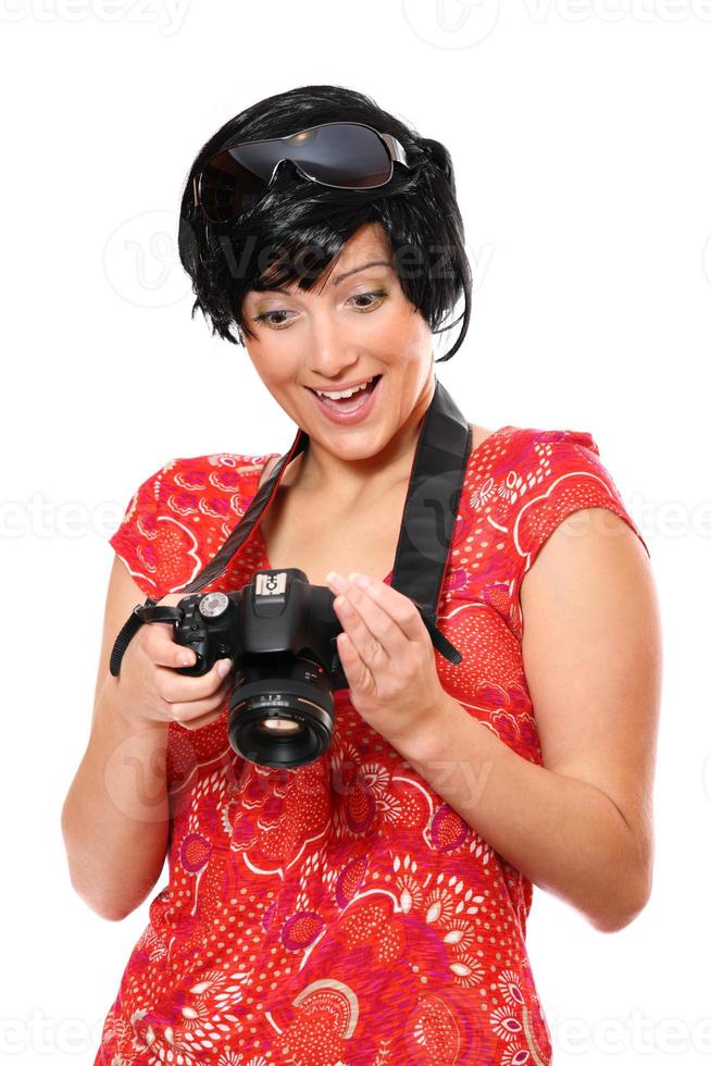 glücklicher Tourist mit einer Kamera foto