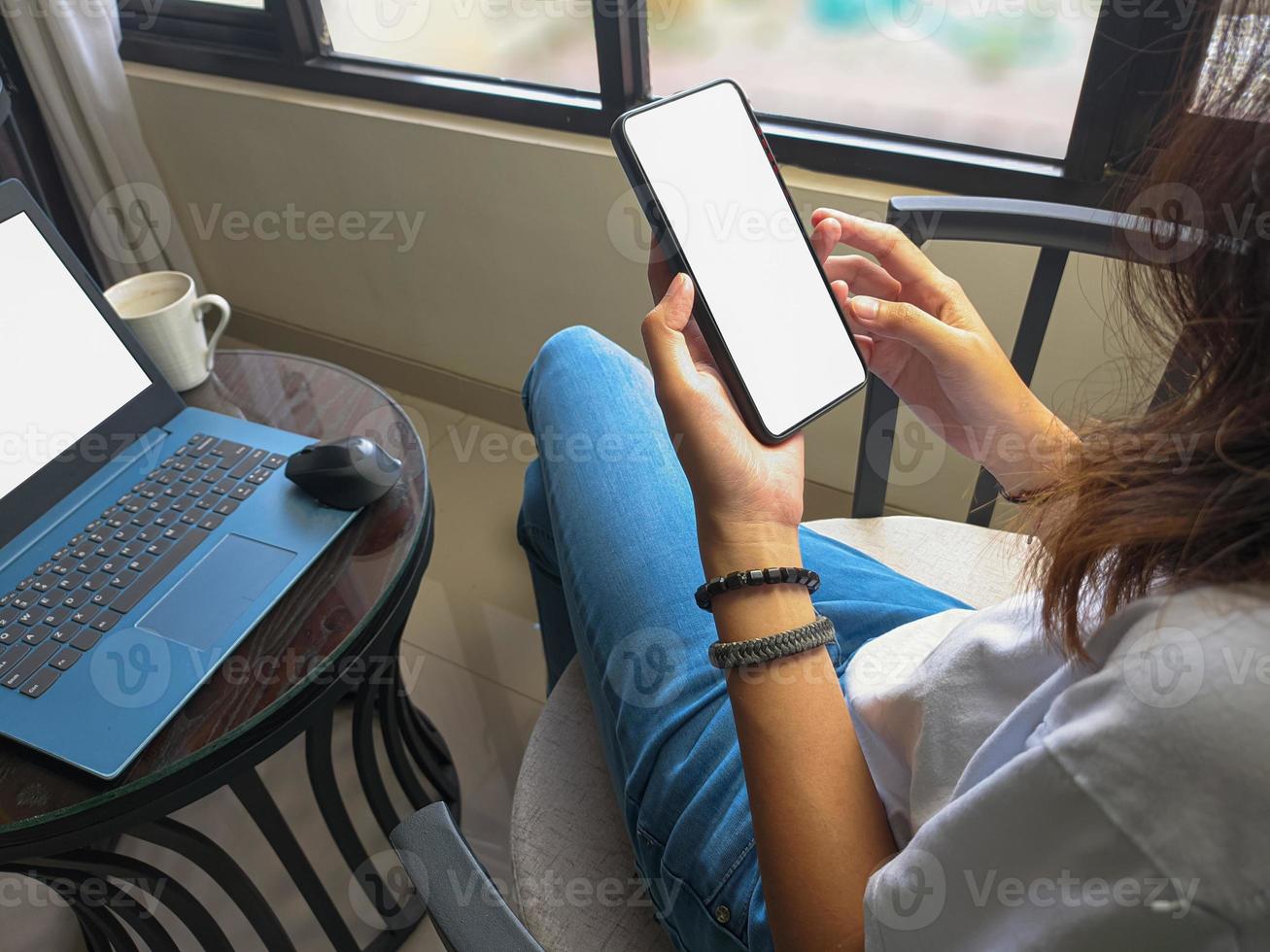 computer, leerer bildschirm telefonmodellbild mit weißem hintergrund für werbung, frauenhand mit laptop und handy auf dem tisch im cafe.mockup foto