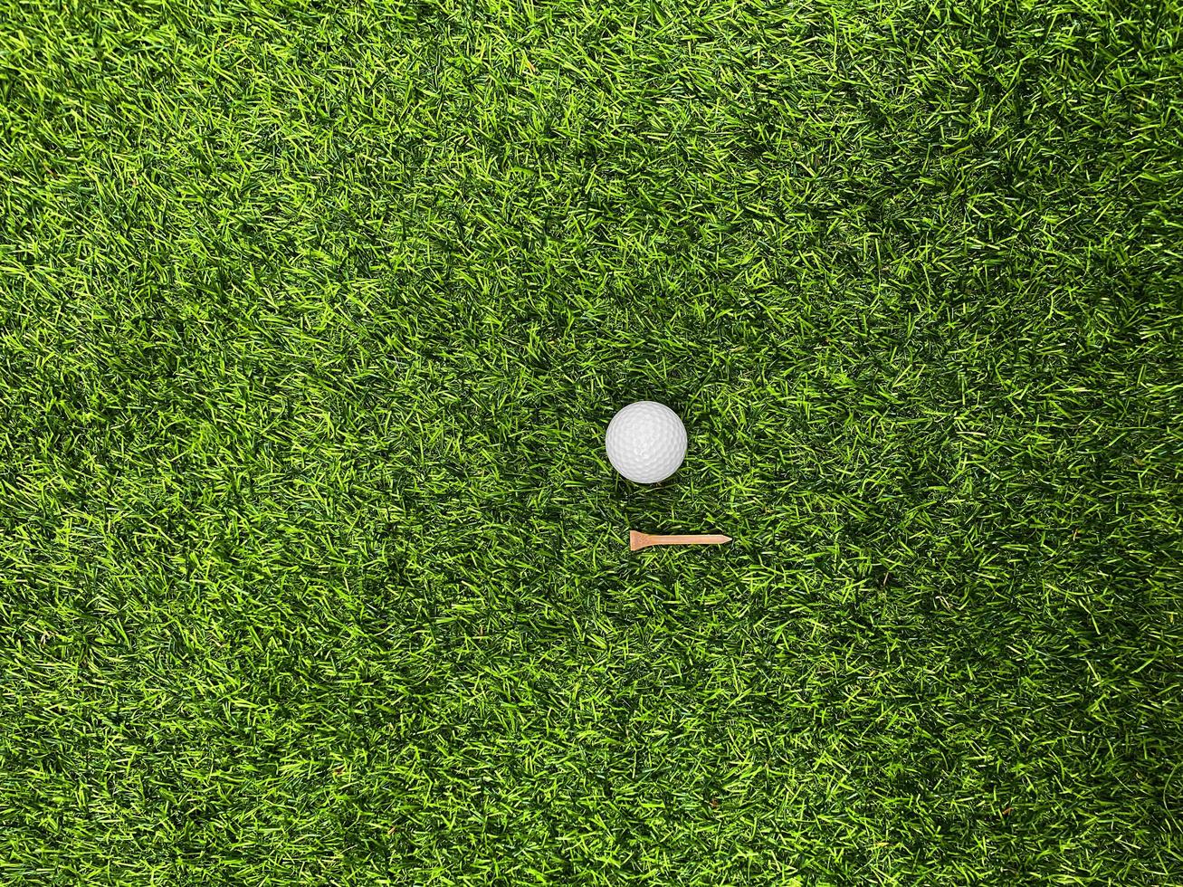 golfball nah oben auf grünem gras auf unscharfer schöner landschaft des golfhintergrundes.konzept internationaler sport, der auf präzisionsfähigkeiten zur gesundheitsentspannung angewiesen ist. foto