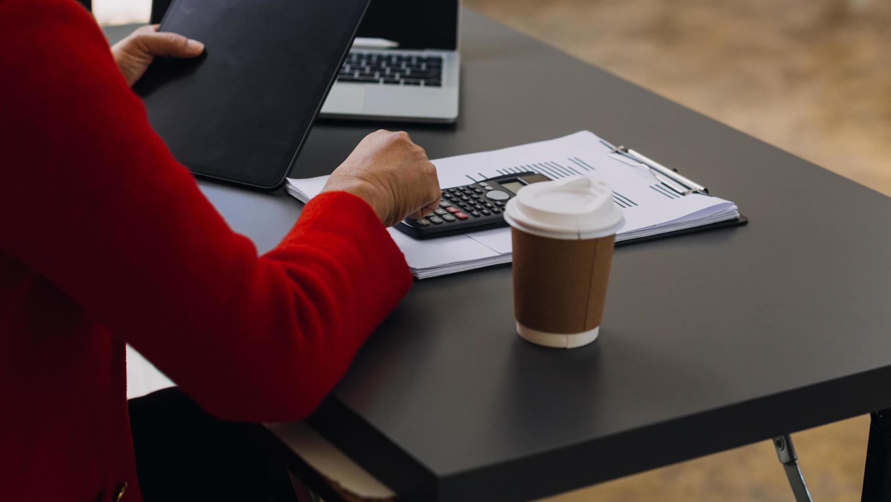 Geschäftsfrau arbeitet mit Laptop-Computer, Tablet und Smartphone im modernen Büro mit virtuellem Symboldiagramm im Modernoffice im Morgenlicht foto