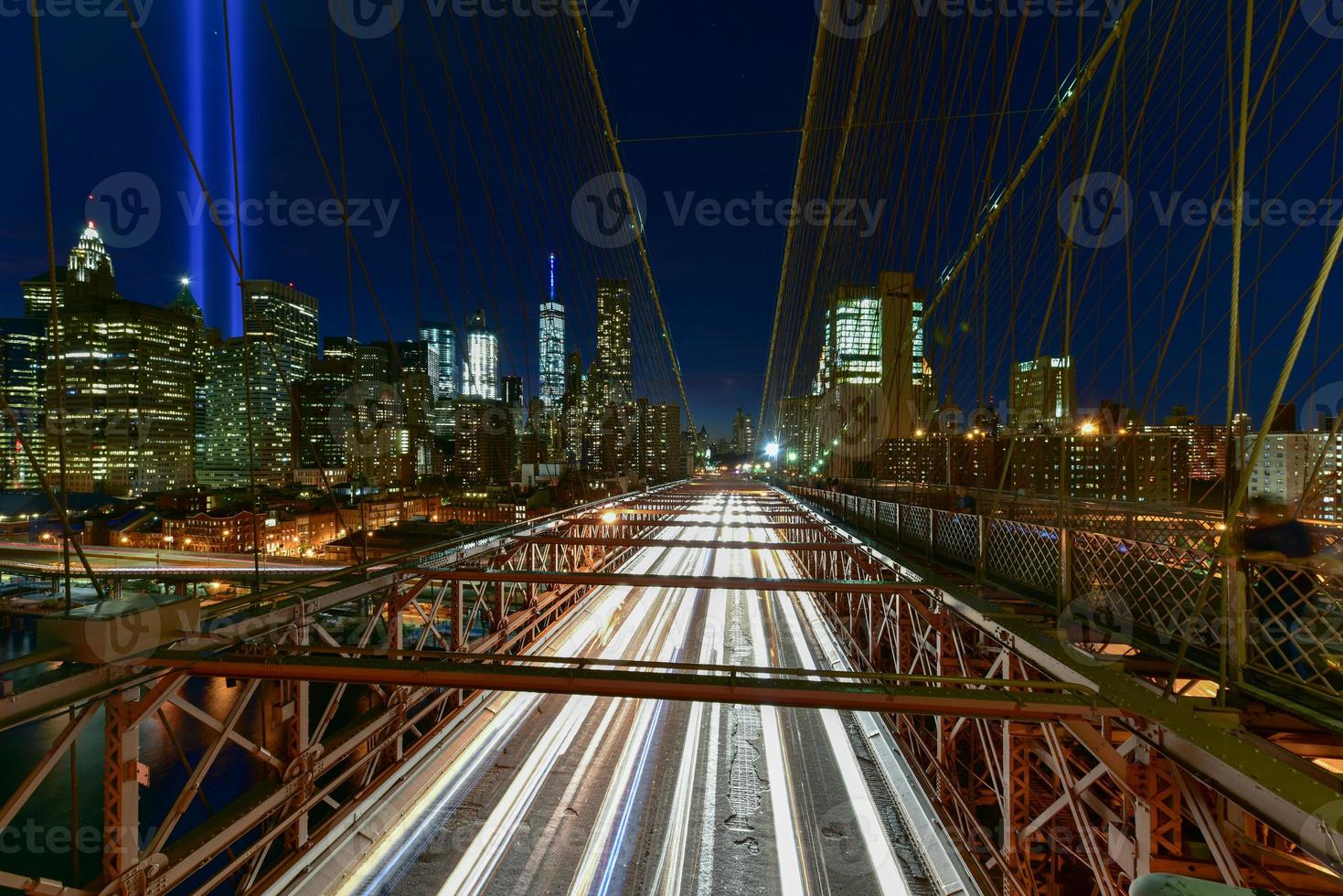 new york city manhattan downtown skyline bei nacht von der brooklyn bridge mit dem tribute in light zur erinnerung an den 11. september. foto